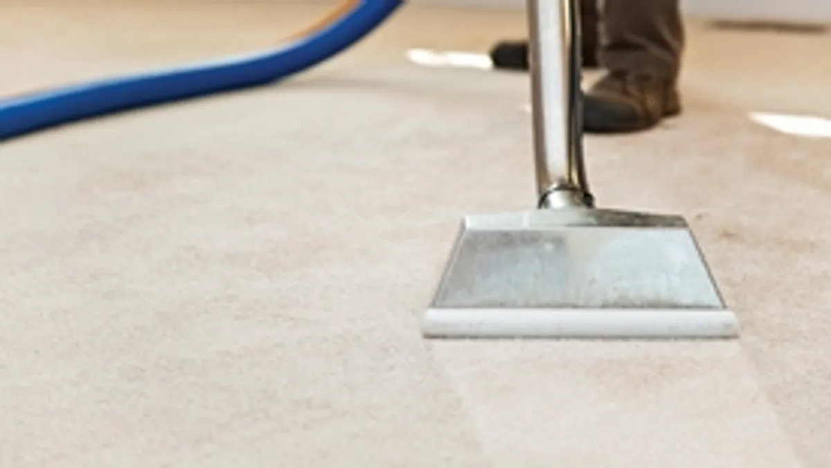 Carpet cleaning wand head gliding over a light carpet during hot-water extraction, Fort Wayne, IN.